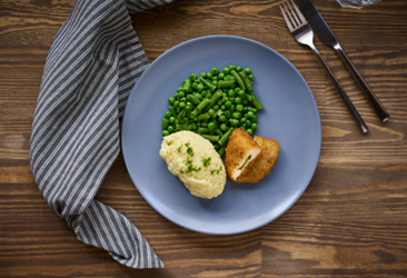 Chicken kiev with mashed potato and peas