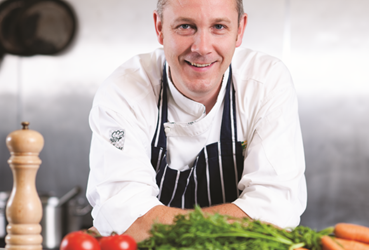 Phil leaning on worktop